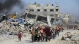 Displaced Palestinians make their way after fleeing the northern part of Gaza amid an Israeli military operation, in Gaza City, Nov. 5, 2024. 