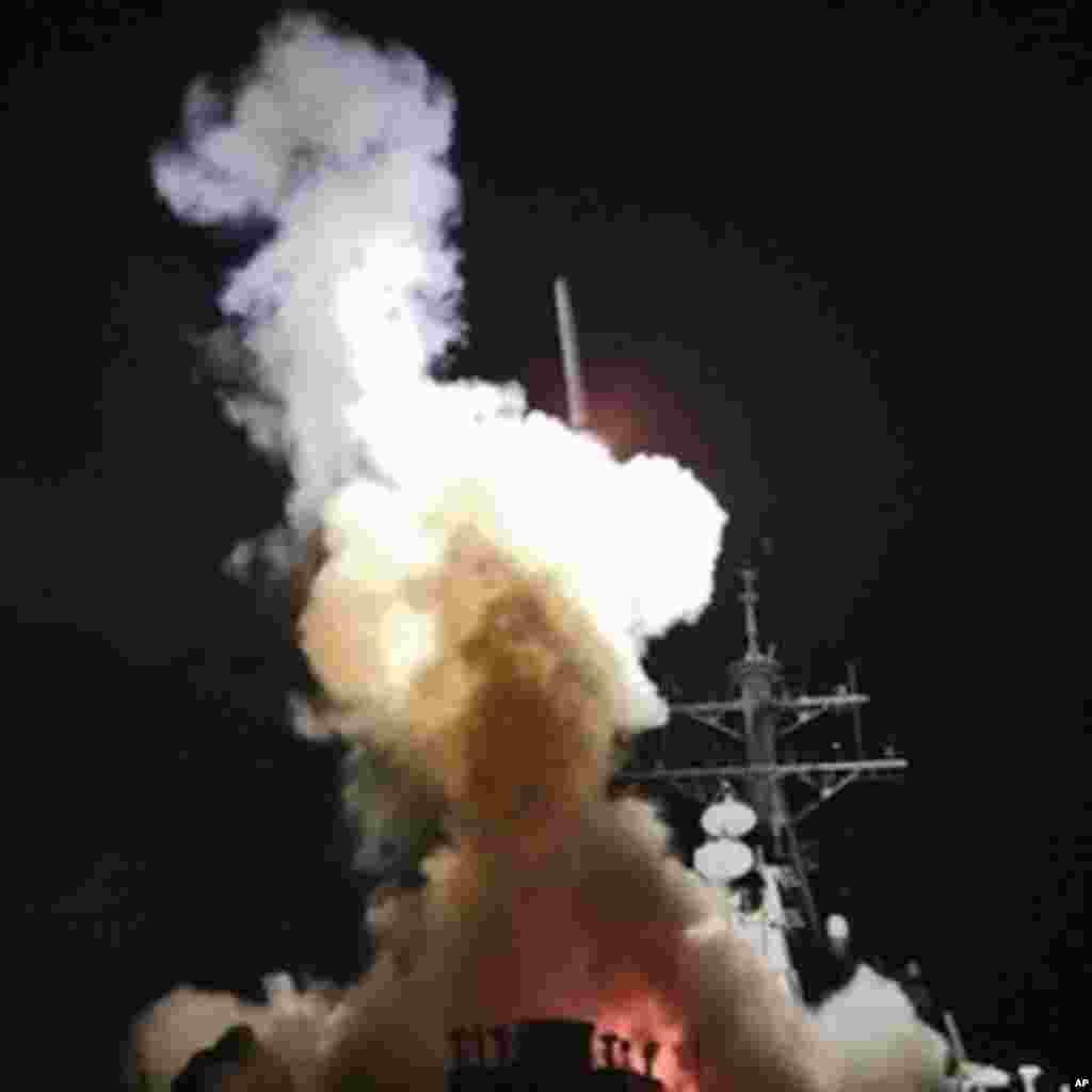This Saturday, March 19, 2011 photo provided by the U.S. Navy shows the Arleigh Burke-class guided-missile destroyer USS Barry (DDG 52) as it launches a Tomahawk missile in support of Operation Odyssey Dawn from the Mediterranean Sea .