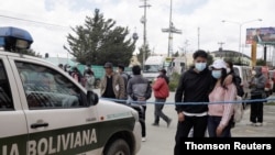 A couple wait for information about the UPEA (El Alto Public University) accident, in El Alto, March 2, 2021.