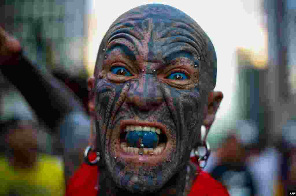 A tattooed runner gestures before the start of the 95rd 15-km Sao Silvestre international race in Sao Paulo, Brazil.