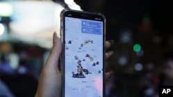 A person's phone shows HKmap.live apps as they join others at a rally to mark Taiwan's National Day, in the Tsim Sha Tsui district in Hong Kong, Oct. 10, 2019. 