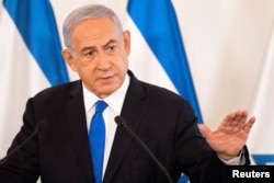 FILE - Israeli Prime Minister Benjamin Netanyahu gestures as he speaks at a military base in Tel Aviv, Israel, May 19, 2021.