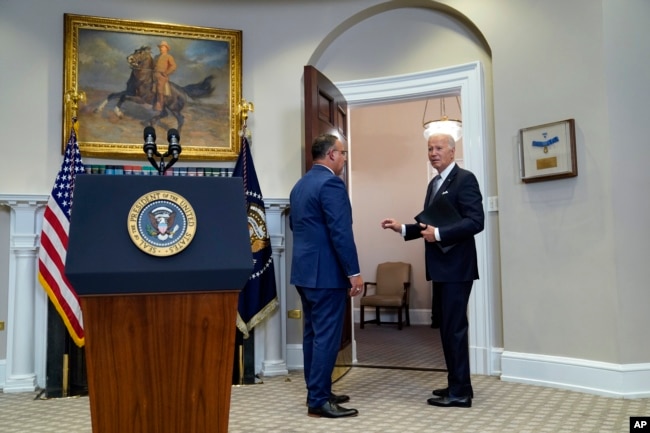 FILE - Joe Biden and Education Secretary Miguel Cardona speak with each other after a media event at the White House earlier in 2023. (AP Photo/Evan Vucci)