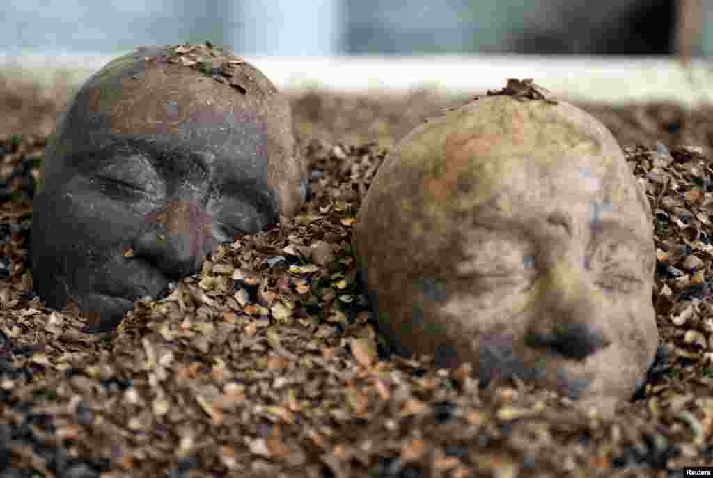 Two chocolate heads are seen in a pile of chocolate at the Brussels Chocolate Festival, Belgium.