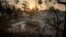 The sun rises behind a home leveled by the Holiday fire in Goleta, Calif., July 7, 2018. Evacuations were ordered as the fire edged into residential areas. 