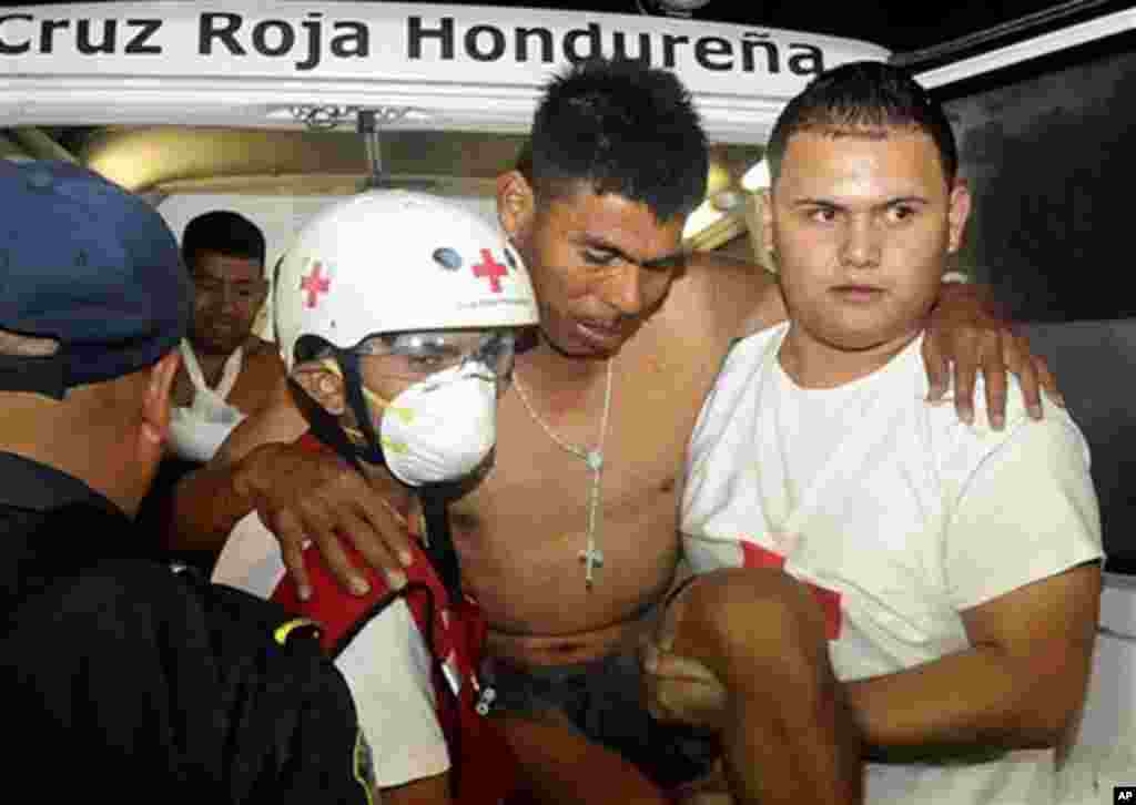 An injured inmate arrives at the hospital after a fire broke out at the prison in Comayagua, Honduras, early February 15, 2012. (AP)