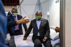 FILE - South African President Cyril Ramaphosa visits the COVID-19 treatment facilities at the NASREC Expo Centre in Johannesburg, South Africa, April 24, 2020.