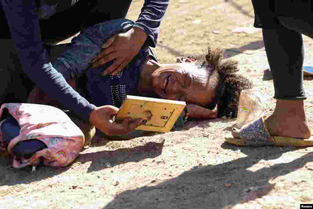 An occupant reacts after people are evicted from a piece of land, called &quot;tent city,&quot; which they illegally occupied near the Green Point tennis courts in Cape Town, South Africa.