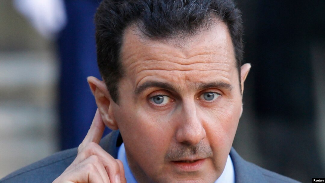 Syria's President Bashar al-Assad answers journalists after a meeting at the Elysee 