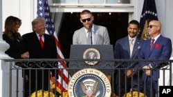 Washington Nationals starting pitcher Stephen Strasburg, center, speaks as First Lady Melania Trump, from left, President Donald Trump, manager Dave Martinez and general manager Mike Rizzo, react at the White House, Nov. 4, 2019, in Washington.