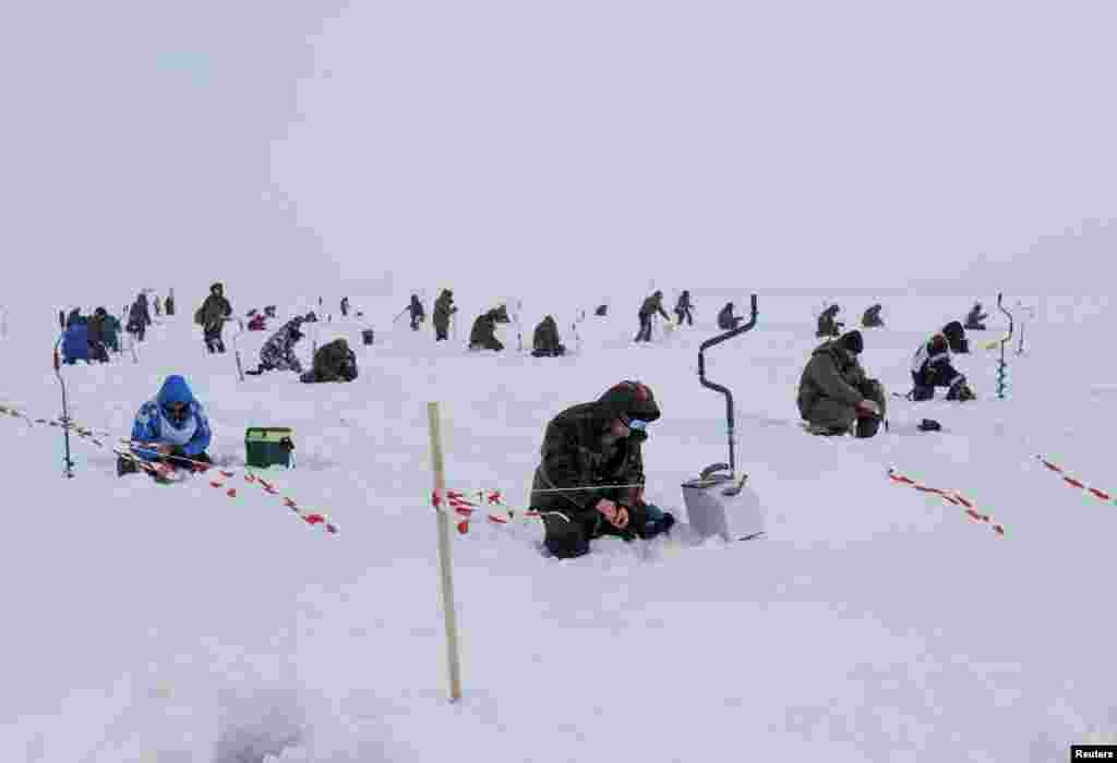 Participants take part in the international ice fishing festival in the town of Chkalovsk, Nizhny Novgorod region, Russia, Feb. 27, 2021.