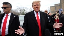 FILE — Former U.S. President and Republican presidential candidate Donald Trump speaks while visiting a polling station in Londonderry, New Hampshire, during the New Hampshire presidential primary, Jan. 23, 2024. 