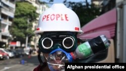 A protester wearing an improvised tear gas protection gear looks on during a demonstration against the military coup in Yangon, Myanmar.