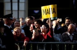 People attend a demonstration demanding justice over the murder of journalist Daphne Caruana Galizia, outside the Parliament in Valletta, Malta, Dec. 2, 2019.