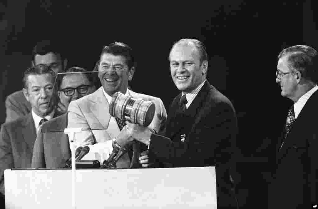 FILE - Gov. Ronald Reagan of California, temporary chairman of the Republican National Convention, turns the gavel over to the permanent chairman, Rep. Gerald R. Ford, of Michigan, at the session in Miami Beach, Fla., Aug. 22, 1972. President Richard Nixon and Vice President Spiro Agnew were renominated.
