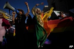 Participants march in the annual Pride Parade in Jerusalem, Thursday, June 2, 2022. Thousands of people marched through the streets of Jerusalem on Thursday in the parade under heavy security over fears of extremism. (AP Photo/Ariel Schalit)