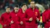 Manchester United's Rio Ferdinand (R) warms up with teammates before their pre-season soccer match against Amazulu Football Club, in Durban, South Africa, July 18, 2012.