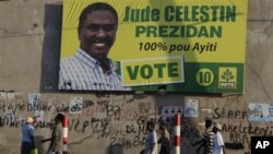 People walk next to a banner of presidential candidate Jude Celestin in Port-au-Prince, Haiti, Jan 26, 2011