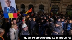 Supporters of far-right candidate Calin Georgescu gather outside Romania's central electoral bureau, after the rejection of his candidacy for the May presidential ballot re-run, in Bucharest, March 9, 2025. 