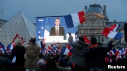 El presidente electo, Emmanuel Macron, es visto en una pantalla gigante cerca del museo del Louvre después de que los resultados se anunciaron en la segunda vuelta de las elecciones presidenciales de 2017 en París, Francia, el 7 de mayo de 2017.