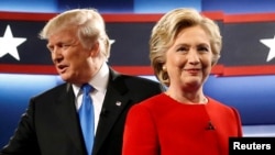 Republican U.S. presidential nominee Donald Trump and Democratic U.S. presidential nominee Hillary Clinton greet one another as they take the stage for their first debate at Hofstra University in Hempstead, New York, Sept. 26, 2016. 