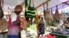 FILE - A woman sells traditional handmade bags called noken at a market in Jayapura, Papua province, Indonesia, Oct. 3, 2024.