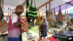 FILE - A woman sells traditional handmade bags called noken at a market in Jayapura, Papua province, Indonesia, Oct. 3, 2024.