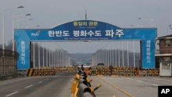 In this Dec. 16, 2019, photo, South Korean army soldiers stand guard at the Unification Bridge, which leads to the Panmunjom in the Demilitarized Zone in Paju, South Korea.