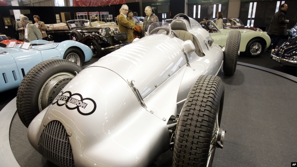FILE - Visitors stand near the 1939 Auto Union D-type on display at the Retromobile vintage cars show in Paris, Friday Feb. 16, 2007. The car, one of the two still in existence, could have become the most expensive car ever but the auction has been postponed. (A