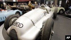 FILE - Visitors stand near the 1939 Auto Union D-type on display at the Retromobile vintage cars show in Paris, Friday Feb. 16, 2007. The car, one of the two still in existence, could have become the most expensive car ever but the auction has been postponed. (A