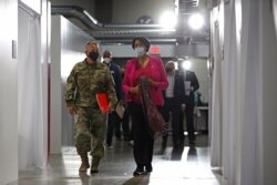 Lt. Gen. Todd Semonite, left, commanding general of the U.S. Army Corps of Engineers, departs a news conference with District of Columbia Mayor Muriel Bowser at a temporary alternate care site constructed in response to the coronavirus outbreak.