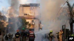 Israeli security and rescue forces work at the site hit by a rocket fired from Lebanon, in Kiryat Bialik, northern Israel, on Sept. 22, 2024.