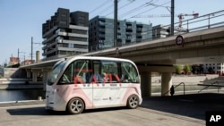 FILE - A driverless shuttle navigates through a district of Lyon, central France, as part of an experiment, Sept. 9, 2016.