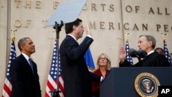 President Barack Obama watches as FBI Director James Comey takes an oath as FBI director from Judge John Walker, right, as Comey's wife Patrice Failor watches at center, during Comey's installation ceremony at FBI Headquarters in Washington, Oct. 28, 2013