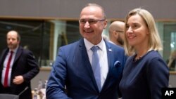 European Union foreign policy chief Federica Mogherini, right, shakes hands with Croatia's Minister for Development Goran Grlic Radman, who is now serving six-month presidency of the  EU bloc, in Brussels, Nov. 25, 2019. 
