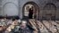 A nun looks at a heavily damaged Church of Multiplication after a fire broke out overnight near the Sea of Galilee in Tabgha, Israel, June 18, 2015.