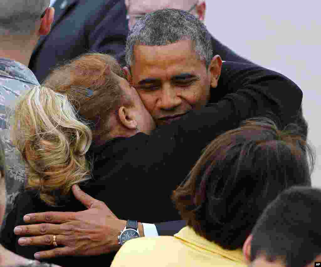 U.S. President Barack Obama hugs a guest on the tarmac after stepping off Air Force One at McGuire Air Force Base, New Jersey, May 28, 2013.