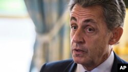FILE - In this Nov. 6, 2017 file photo, former French President Nicolas Sarkozy attends newly named member of the Constitutional Council Dominique Lottin's oath-taking ceremony at the Elysee Palace in Paris.