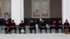 Sniffer dogs and members of Burma's bomb squad rest after checking Myanmar International Convention Center, the venue for the 24th ASEAN Summit for explosives in Naypyitaw, Burma, May 9, 2014.