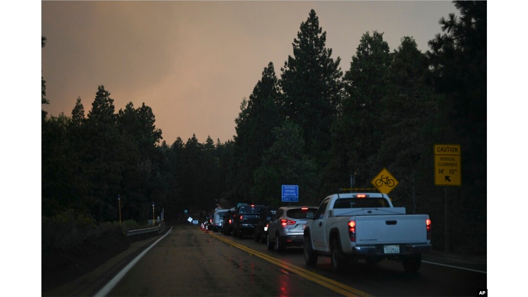 Motorists line up in the outskirts of town as smoke from the Line Fire fills the air Sept. 7, 2024, in Running Springs, California.