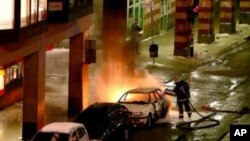 This video image show emergency services as they attend the scene after a car exploded in the center of Stockholm, Sweden, 11 Dec 2010