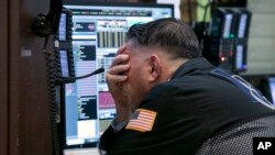 Trader Jonathan Mueller works in his booth on the floor of the New York Stock Exchange, Oct. 26, 2018. 