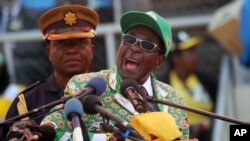 FILE: Zimbabwe President and Zanu-PF leader Robert Mugabe addresses party supporters at his last campaign rally in Harare, July, 28, 2013.