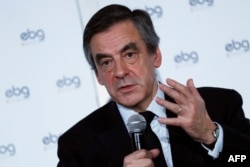 FILE - French presidential election candidate for the right-wing Les Republicains (LR) party Francois Fillon gestures as he speaks during a debate organized by the EBG (Electronic Business Group), Jan. 31, 2017, in Paris.