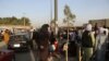 Hundreds of people gather near an evacuation control checkpoint during ongoing evacuations at Hamid Karzai International Airport, in Kabul, Afghanistan, Aug. 25, 2021. 