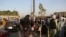 Hundreds of people gather near an evacuation control checkpoint during ongoing evacuations at Hamid Karzai International Airport, in Kabul, Afghanistan, Aug. 25, 2021. 