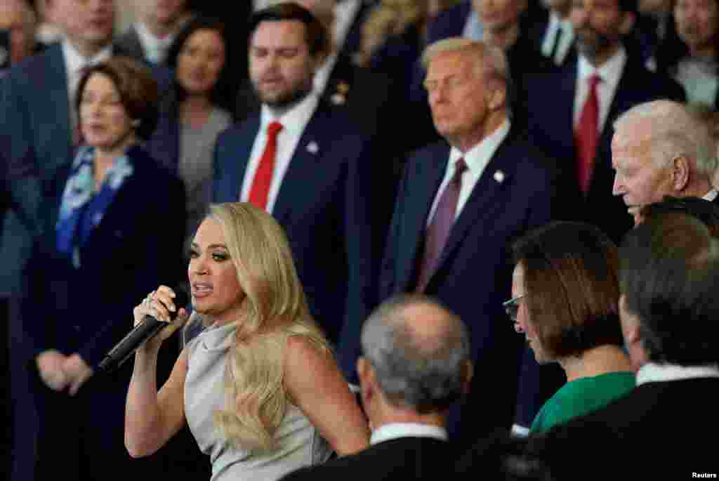 President Donald Trump and Vice President JD Vance listen as Carrie Underwood performs America the Beautiful during the 60th Presidential Inauguration in the Rotunda of the U.S. Capitol in Washington, Jan. 20, 2025. 