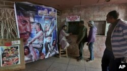 Cinema-goers buy tickets to watch a film at a local cinema in Karachi, Pakistan, Feb. 1, 2020. 