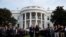 President Donald Trump and first lady Melania Trump participate in a moment of silence honoring the victims of the Sept. 11, 2001, terrorist attacks, on the South Lawn of the White House, in Washington, Sept. 11, 2019.
