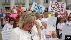 FILE - Laurie Holt, the mother of Josh Holt, an American jailed in Venezuela, cries during a rally at the Utah State Capitol in Salt Lake City, July 30, 2016. 